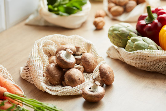 White Raw Mushrooms In Reusable Bag For Shopping.