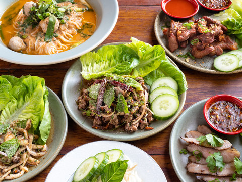 Traditional Northern Thai food cooked fresh. Pork laab, larb, mushrooms, spicy chile soup, beef meatballs, flank steak, soft boiled egg, papaya salad.