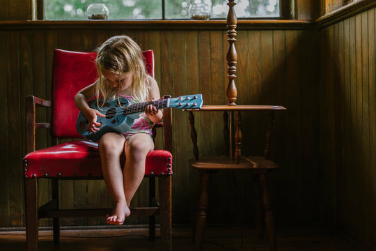 Family Lifestyle image of Young girl playing guitar