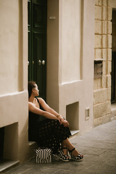 Portrait of a young beautiful woman walking in old town