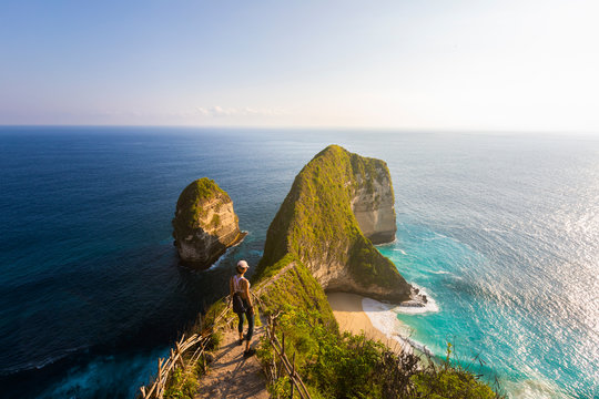 Young asian woman walking down a coastal trail