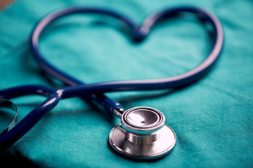 A stethoscope shaping a heart on a medical uniform, closeup - 270647432