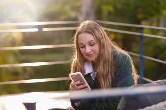 Teen High School Student Using A Mobile Phone