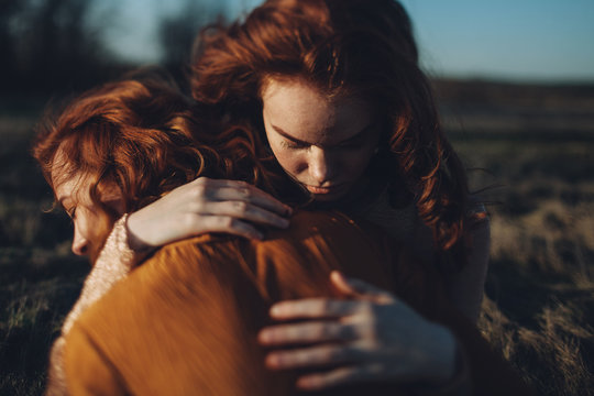 Friends hugging each other outdoors