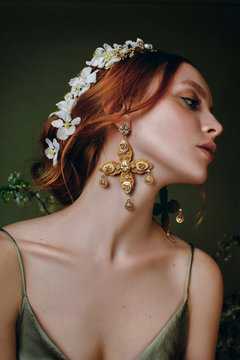 Portrait of a red headed young woman wearing jewelery