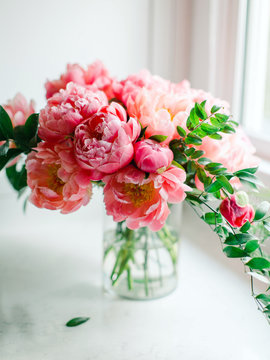 Pink peonies in glass vase