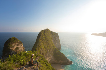 Young asian woman walking down a coastal trail