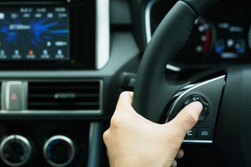 The concept of using hands to press the volume control switch in the car