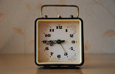 alarm clock on light background