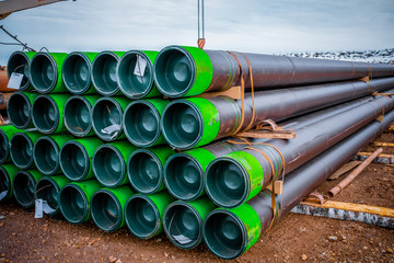 Stacked steel pipe with sunlight  reflecting on the interior walls. Stack of new metal pipes....