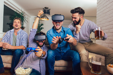 Happy friends playing video games with virtual reality glasses - Young people having fun with new technology console online