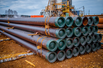 Stacked steel pipe with sunlight  reflecting on the interior walls. Stack of new metal pipes....