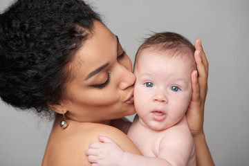Pretty woman holding a baby in her arms