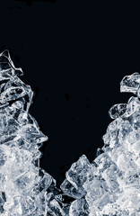 Pieces of crushed ice cubes on black background. 