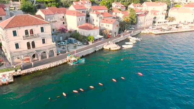 aerial view of perast city on sunset. summer vacation concept. town at seashore with mountains