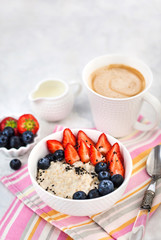 Healthy breakfast with oatmeal porridge, fresh berries and coffee