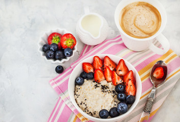 Healthy breakfast with oatmeal porridge, fresh berries and coffee