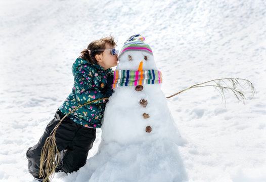 Little girl with a snowman