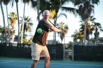 Middle age man playing tennis