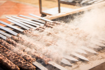 Cooking Lula kebab, a traditional Turkish dish, meat strung on a skewer