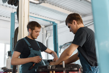 Colleagues working in car repair center