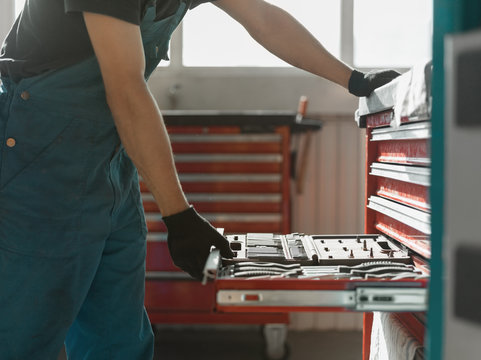 Crop Man Opening Drawer With Tools