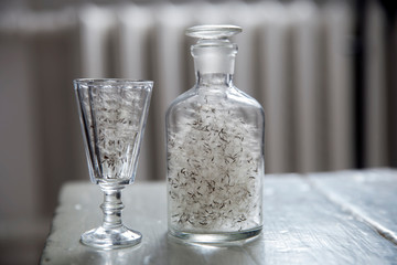 The dandelion fluffs in a glass damask and glass