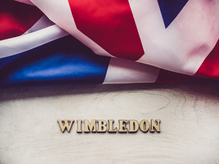 Fototapeta na wymiar WIMBLEDON. Wooden, unpainted letters on a white table. Close-up, top view. Beautiful photo for invitation card