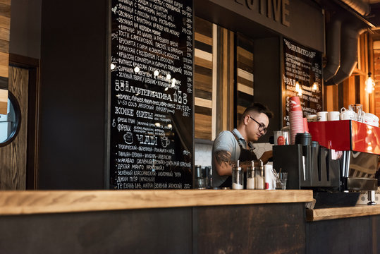 Bartender in process of coffee making - Powered by Adobe