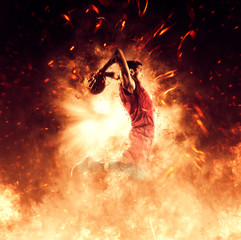 Man basketball player on flames background