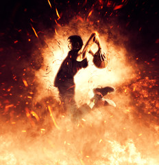 Man basketball player on flames background