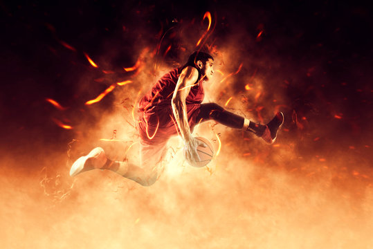 Man basketball player on flames background