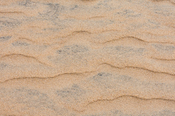 Fototapeta na wymiar Sea beach clean sand pattern made by sea waves after gone in sunny day.
