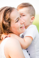 Little boy kisses mom on the cheek