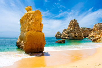 Praia de Marinha most beautiful beach in Algarve Portugal. beautiful landscape clear green and blue water cliffs and rock formations on Coast of Atlantic Ocean