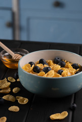 Morning healthy food. Vegetarian corn flakes on table on kitchen. Organic sweet delicious meal