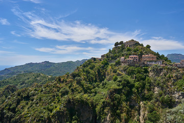 Landscape or cityscape picture of Italian town Savoca in Sicily. Beautiful historic town from middle ages, houses made from stone with terracotta roofs., placed on high mountains of sicilian coast.