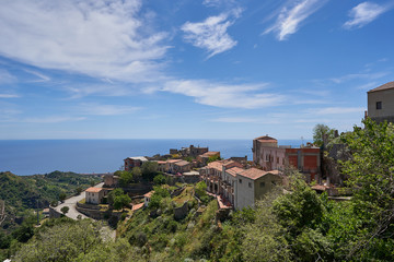 Fototapeta na wymiar Landscape picture of town Savoca which is a municipality in the Province of Messina in the Italian region Sicily. Beautiful historic town from middle ages, houses made from stone with terracotta roofs