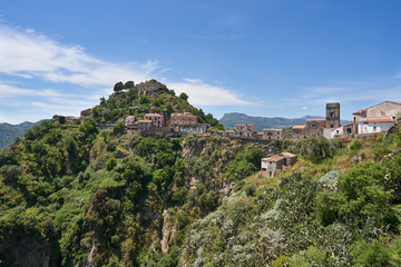 Fototapeta na wymiar Landscape or cityscape picture of Italian town Savoca in Sicily. Beautiful historic town from middle ages, houses made from stone with terracotta roofs., placed on high mountains of sicilian coast.