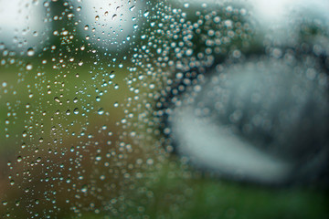 blur backgruond,Rain water on the car glass.