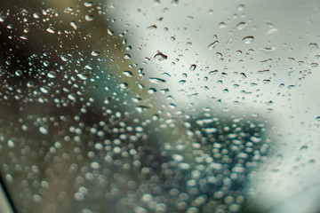 blur backgruond,Rain water on the car glass.
