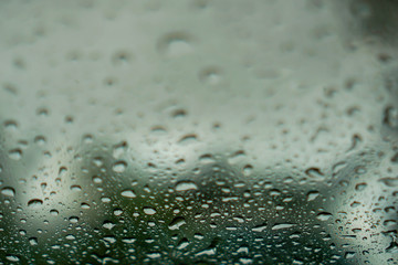 blur backgruond,Rain water on the car glass.