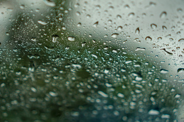 blur backgruond,Rain water on the car glass.