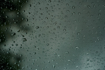blur backgruond,Rain water on the car glass.