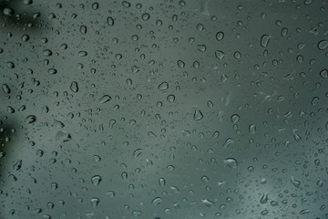 blur backgruond,Rain water on the car glass.