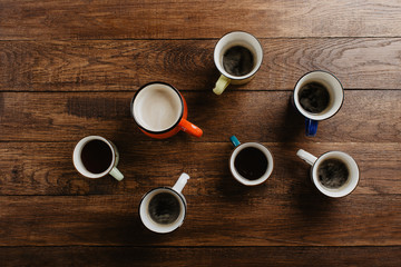 various mugs of coffee, wooden table, top view