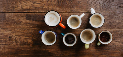 various mugs of coffee, wooden table, top view