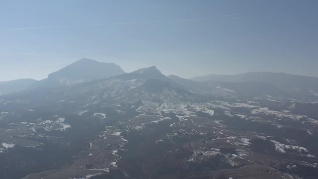 Valley in Eastern Serbia with Stol mountain in haze 4K drone video