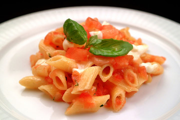 Italian food recipes, pasta Penne with fresh tomatoes.
