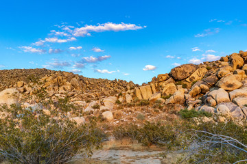 Fototapeta na wymiar Large boulders on a hill during sunset lighting